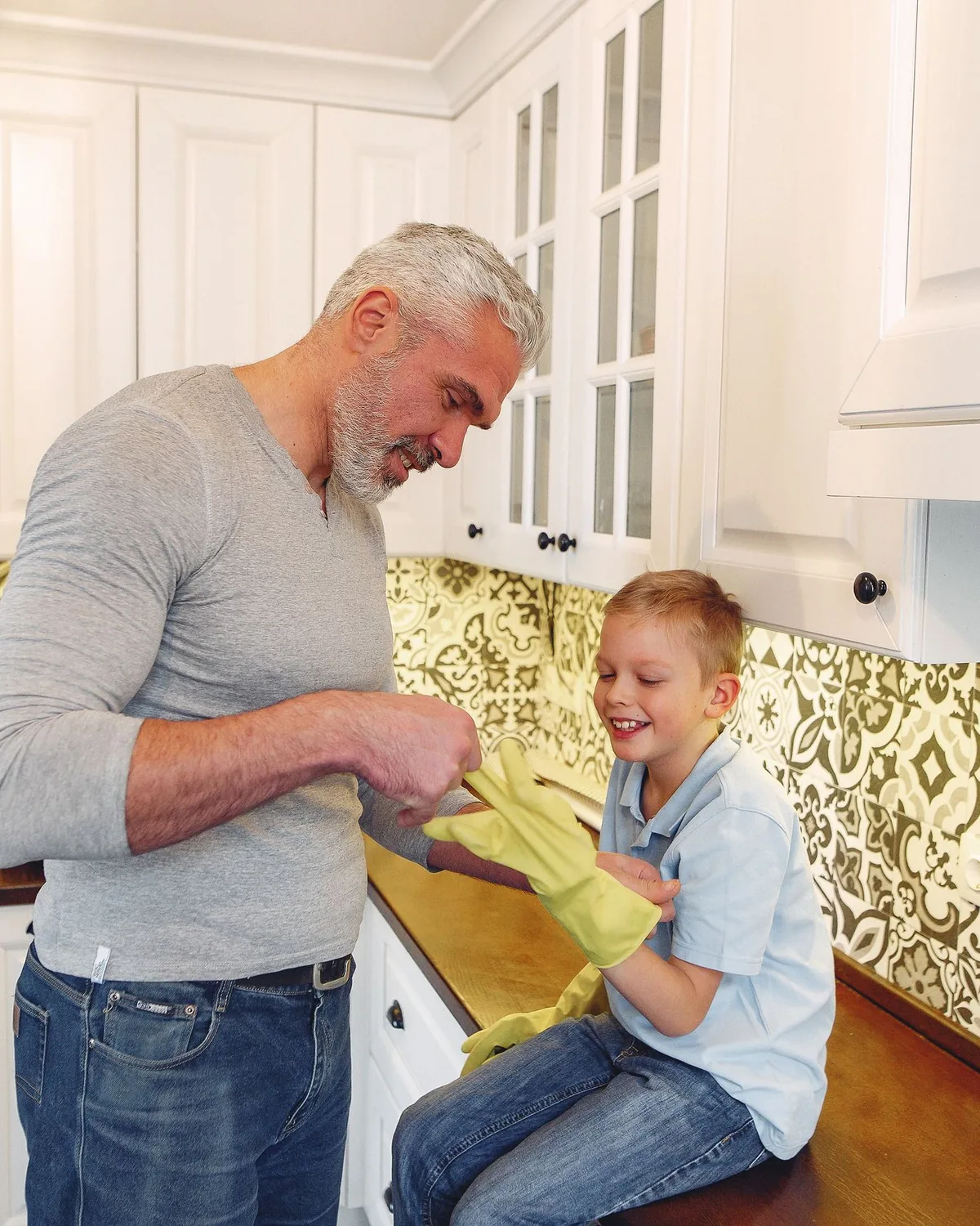 A father and son together in a clean, bright kitchen